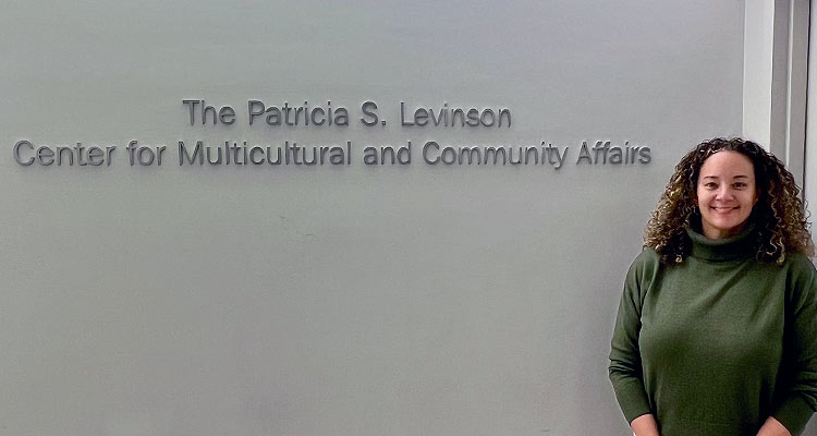 Image of Ann-Gel Palermo Standing in front of the CMCA signage